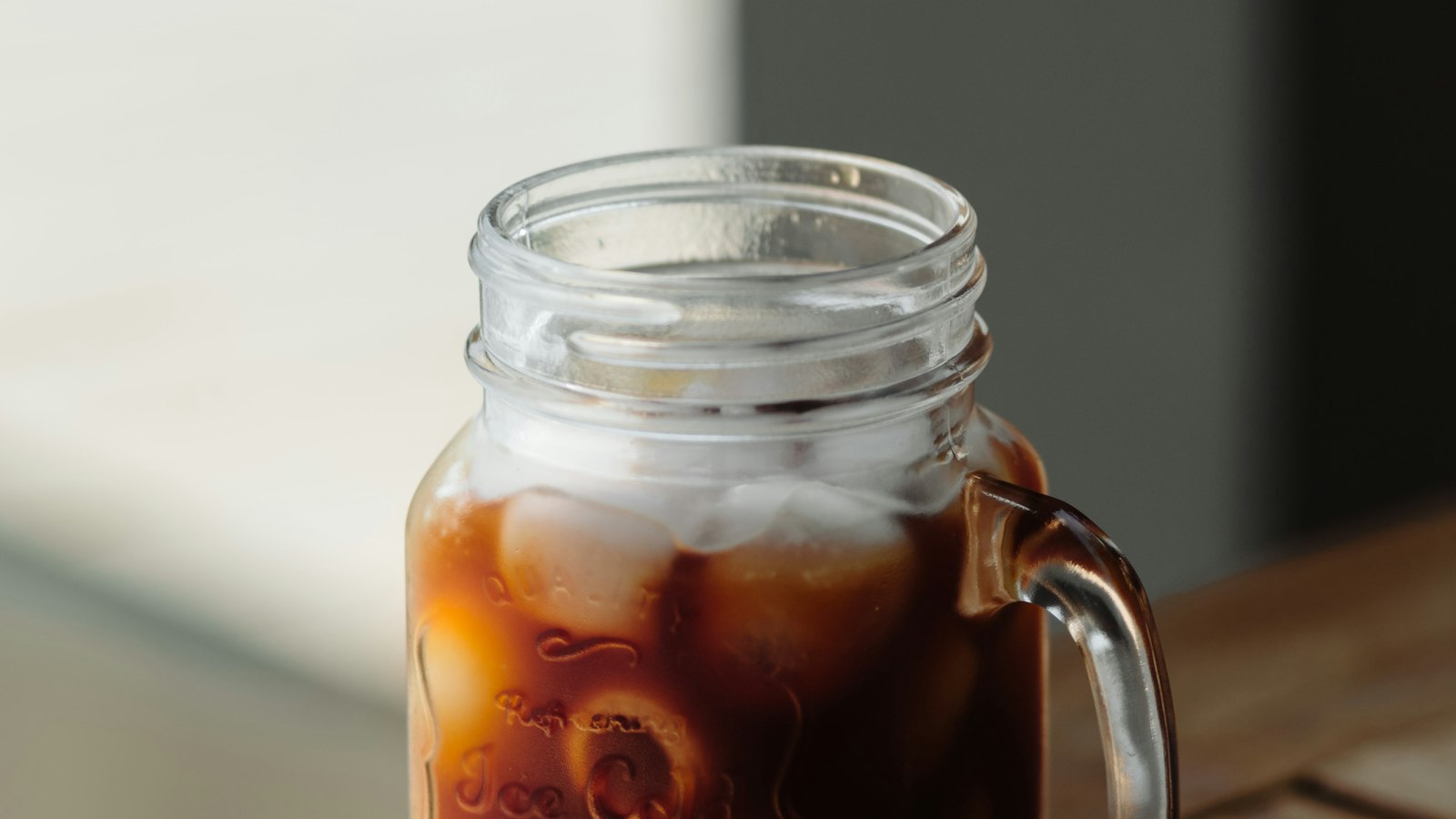 Iced cold brew coffee in a glass mason jar mug
